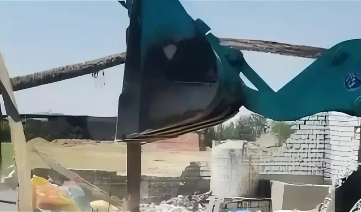 جرافة تزيل بناء مخالف